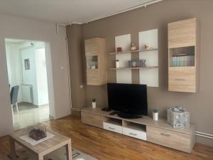a living room with a tv and a table at Apartments Manila in Zagreb
