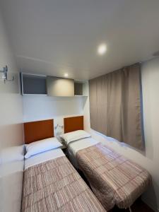 a bedroom with two beds and a window in it at Camping Serenissima in Malcontenta