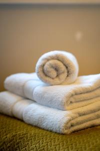 a pile of towels sitting on top of a table at Spence Lodge: Beautiful 2-Bedroom Stone Cottage in Alnmouth