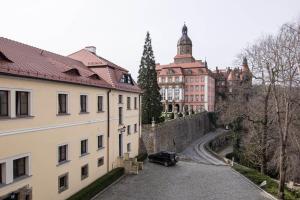 a car parked on a street next to buildings at Hotel Zamkowy in Wałbrzych