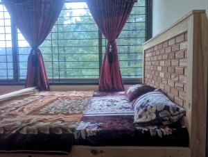 a bed in a room with a brick wall at Hill Heaven Resort in Abbottabad