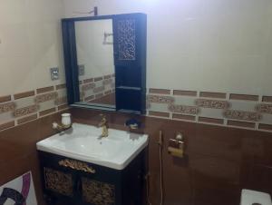 a bathroom with a sink and a mirror at Hill Heaven Resort in Abbottabad