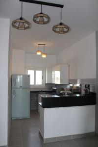 a kitchen with a refrigerator and a counter top at Paradise Ras Sudr, Home in Raʼs Matarma