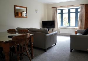 a living room with a couch and a table at The Uplands Apartments in Saint Helier Jersey