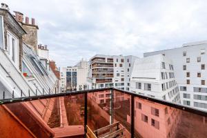 a view of a city from a balcony at GuestReady - Comfort near Parc Clichy-Batignolles in Paris