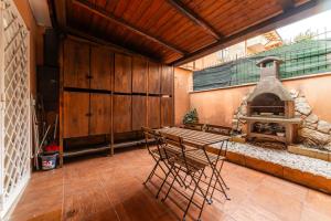 a dining room with a table and a fireplace at Casa Sincera - Policlinico Gemelli - Metro Battistini in Rome