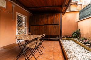 a table and a chair on a patio at Casa Sincera - Policlinico Gemelli - Metro Battistini in Rome