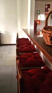 a row of red blankets sitting next to a counter at Casa Flora - Vale da Telha - Nature - Surf & Sun in Aljezur +54 photos