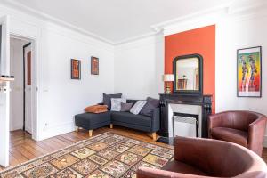 a living room with a couch and a fireplace at GuestReady - Luxury Living near Panthéon in Paris