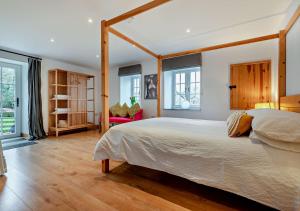 a bedroom with a large bed with a wooden frame at The Cider House - Launceston in Werrington