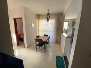 a kitchen and dining room with a table and chairs at Lindo Apto Grande e Novíssimo no Centro in Juiz de Fora