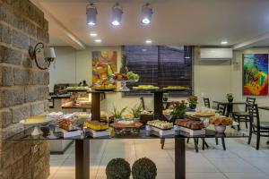 a buffet with many different types of food on a table at Flat Pietra in Florianópolis