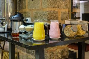 a table with four different colored vases on it at Flat Pietra in Florianópolis