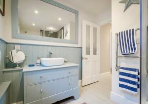 a bathroom with a sink and a mirror at Penrose in Downderry +30 photos