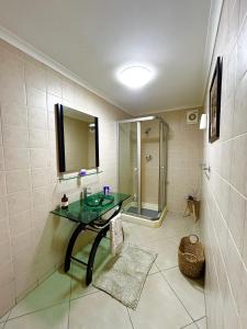 a bathroom with a glass sink and a shower at Lyndhurst in Margate