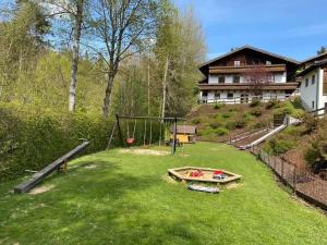 a large yard with a swing set in the grass at Hauzenberg App 303 in Freudensee