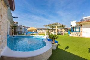 a swimming pool in the yard of a house at Re Sole Resort&Spa in Grottaglie