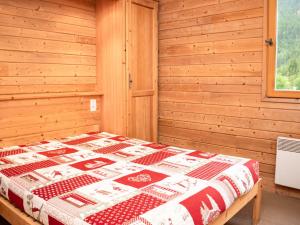 a bedroom with a bed in a wooden room at Appartement Uvernet-Fours, 2 pièces, 6 personnes - FR-1-504-161 in Uvernet