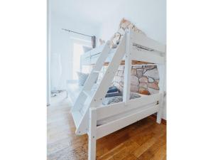 a white bunk bed with a ladder in a room at Sterkrade 1 Modern retreat in Oberhausen