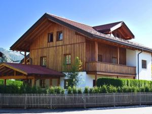 a wooden house with a fence in front of it at Favorite place 1 in Garmisch-Partenkirchen