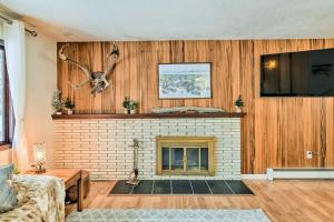 a living room with a fireplace and a flat screen tv at West Anchorage Home Near Airport! home in Anchorage