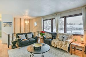 a living room with a couch and a table at West Anchorage Home Near Airport! home in Anchorage