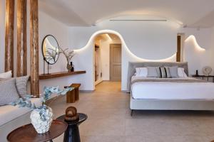 a bedroom with a bed and a living room at Phos The Boutique in Akrotiri
