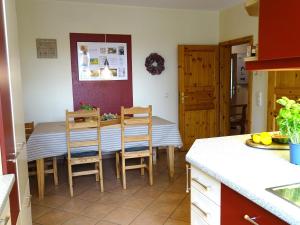 a kitchen and dining room with a table and chairs at Bauerngarten in Grömitz +16 photos