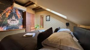 a bedroom with two beds and a painting on the wall at Villa Regia in Košice
