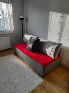 a couch sitting on the floor in a room at Apartament Leśna 18 in Olsztyn