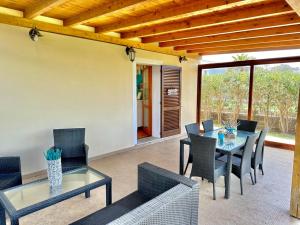 a patio with a table and chairs on a patio at Casa Alba in Stintino