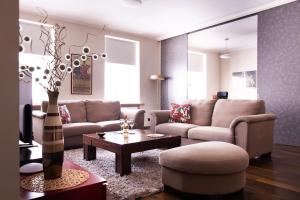 a living room with a couch and a coffee table at Piotrkowska 89 Apartments & Suites in Łódź
