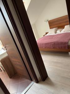 a door leading into a bedroom with a bed at Panorama Hlohovec in Hlohovec