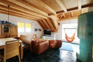 a living room with a couch and a table at Traumwohnung Schluchsee, 2 Schlafzimmer, Blick zum See in Schluchsee