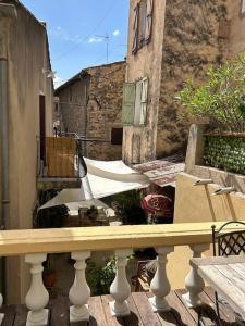 a balcony with a table in front of a building at LemonTree Terrace village centre in Cotignac