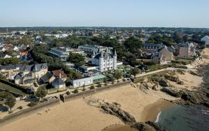 - une vue aérienne sur une ville avec une plage et des bâtiments dans l'établissement Hôtel Château des Tourelles, Thalasso et piscine d'eau de mer chauffée, à Pornichet