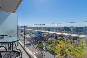 a balcony with a view of a city at Vision Apartments On Morphett with Parking in Adelaide