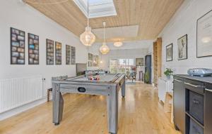 a ping pong table in the middle of a room at Amazing Home In Skagen With Kitchen in Skagen