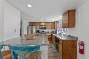 a kitchen with wooden cabinets and a counter top at 217 E Hildreth Ave, Unit 4 in Wildwood +17 photos