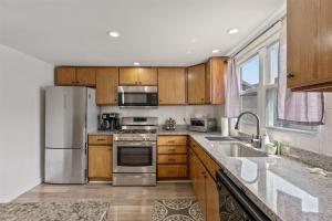 a kitchen with wooden cabinets and stainless steel appliances at 217 E Hildreth Ave, Unit 4 in Wildwood