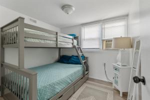a bedroom with a bunk bed with a ladder at 217 E Hildreth Ave, Unit 4 in Wildwood