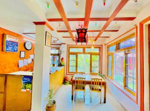a dining room with a table and chairs at Grand view lodge and Restaurant Dharamshala - Partial Prepayment required to confirm booking in Dharamshala