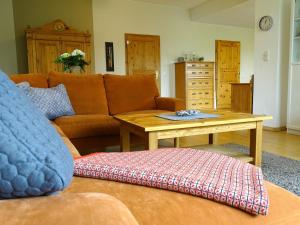 a living room with a couch and a coffee table at Bauerngarten in Grömitz
