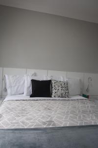 a white bed with two pillows on top of it at Lunare Hotel Pinheiros in Sao Paulo