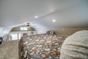 a bedroom with a bed with a floral blanket at Pocatello Vacation Rental with Mountain Views! in Pocatello