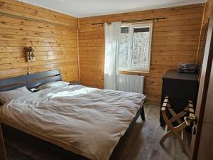 a bedroom with a bed and a wooden wall at Vila Călin Sinaia in Sinaia