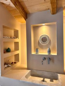 a bathroom with a sink and a mirror at Peppermint Bay in Skopelos Town