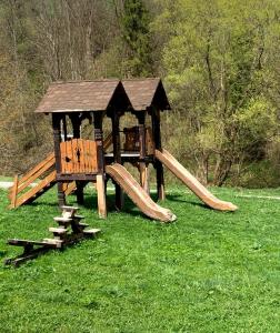 オリアウチックにあるSmerekova Hataの芝生の中に木製のガゼボがある遊び場