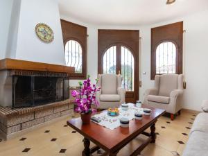 a living room with a fireplace and a table at Villa Casa Philippe by Interhome in Miami Platja