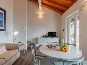 a living room with a table and a couch at Apartment Europa-1 by Interhome in Ledro